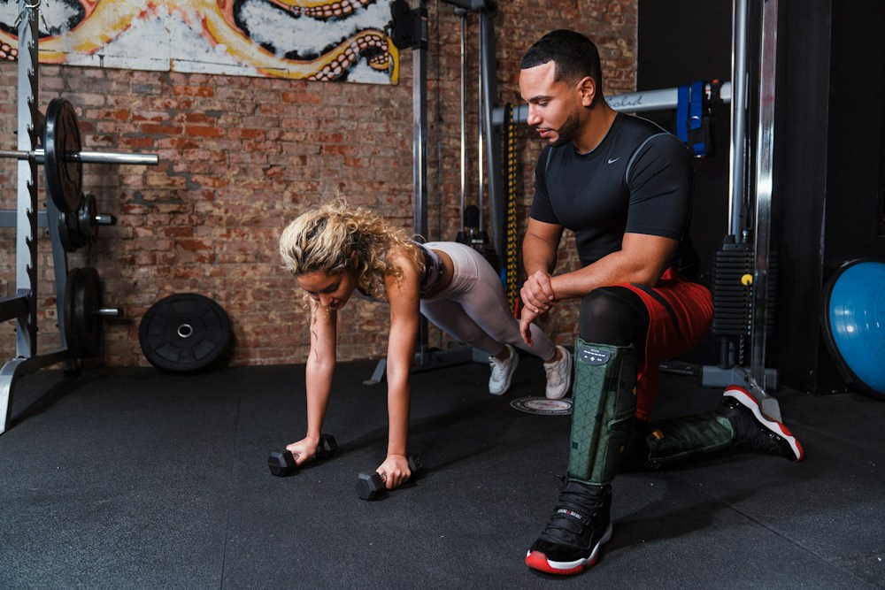 Coach guiding a member during a gym session